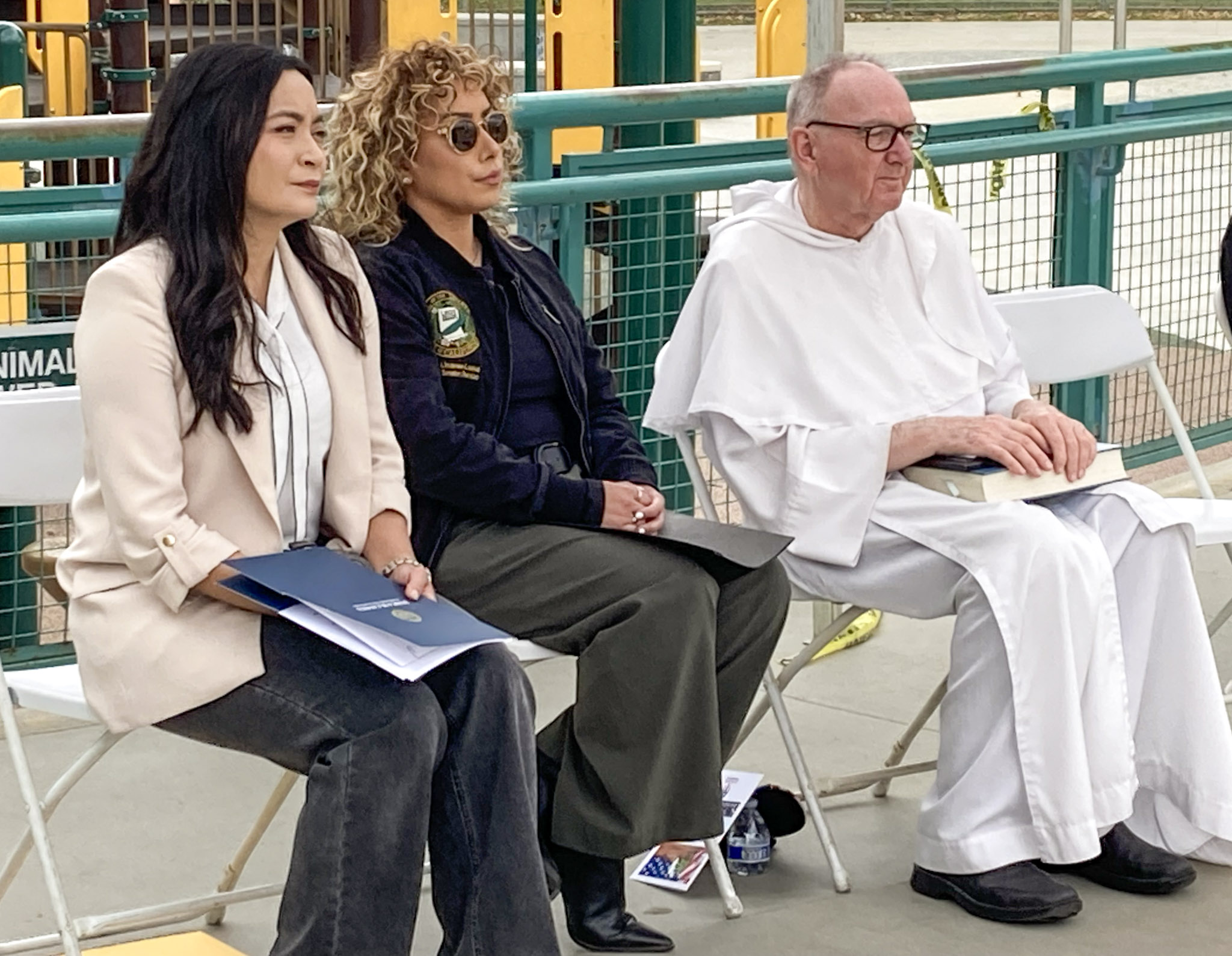 Veteran seated with guest under canopy