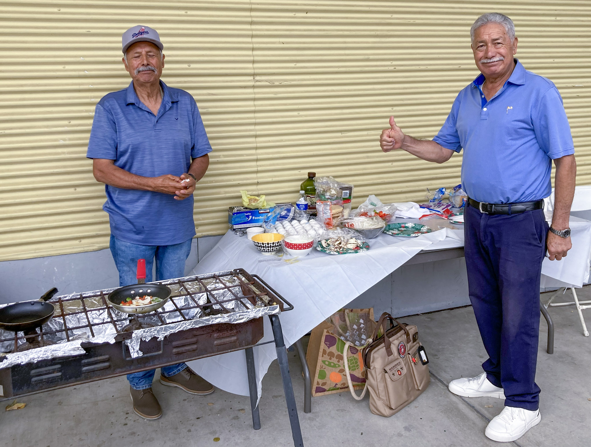 Group smiling beside BBQ raffle prize